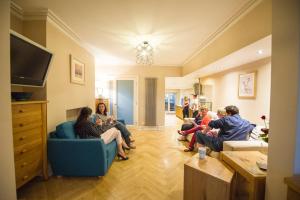 a group of people sitting in a living room at Chester Apartments in Chester