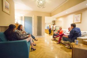 a group of people sitting in a living room at Chester Apartments in Chester