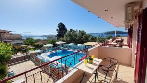 a view of a swimming pool from the balcony of a house at Sunrise studios Lefkada in Nydri