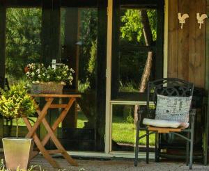 a chair sitting next to a table and a window at het Atelier in Eext