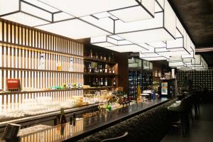a bar in a restaurant with a chandelier at ManukabyHavis Boutique Hotel in Nagoya
