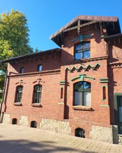 a brick building with windows on the side of it at Apartment K21 Stare Tychy in Tychy