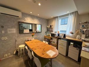 a kitchen with a wooden table in the middle of it at Ficus Tokyo in Tokyo