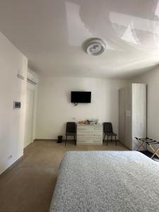 a bedroom with a bed and a flat screen tv at YouRoominRome in Rome