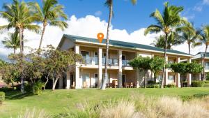 an exterior view of a house with palm trees at ❤PiH❤ Mauna Kea SunsetsOcean and Golf ViewsOptional Mauna Kea Hotel Privileges in Hapuna Beach