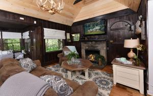 a living room with a couch and a fireplace at On the River in Gatlinburg