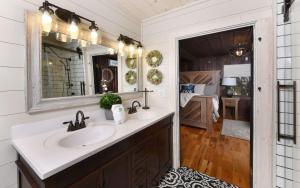 a bathroom with two sinks and a mirror at On the River in Gatlinburg +17 photos