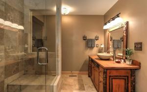 a bathroom with a sink and a shower at Wine Down Cottage - Mountain Views Sip Wine Fireside Watch Netflix Play Golf in Jasper +27 photos