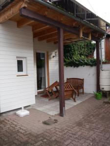 a wooden bench under a pergola on a patio at Haus-Wolter in Goslar