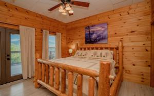a bedroom with a bed in a log cabin at Absolute Heaven in Gatlinburg