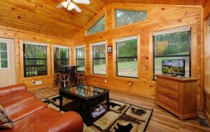 a living room with a couch and a table at Dogwood Acres in Pigeon Forge
