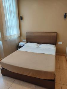 a bed in a small room with a bed sidx sidx sidx at The Pines Hotel in Tanah Rata