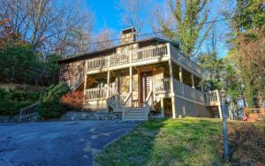 a large wooden house with a large porch at Bearfoot Lodge in Gatlinburg