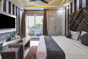 a hotel room with a large bed and a tv at Hotel Downtown, Sector 51 in Noida