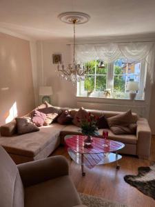 a living room with a couch and a glass table at FeWo Auszeit Andreas Schreiner in Arrach