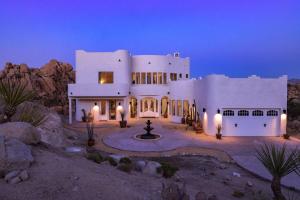 a large white house in the desert at night at Casa Blanca by Fieldtrip Boulder Estate with Hot Tub Soaking Pool Outdoor Shower in Yucca Valley