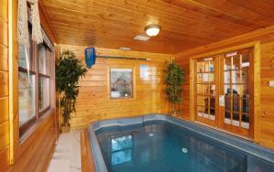 a swimming pool inside of a wooden house at Skinny Dipping in Gatlinburg