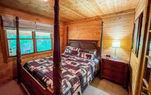 a bedroom with a bed in a log cabin at Skinny Dipping in Gatlinburg +23 photos