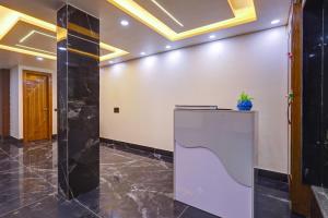 a lobby with a reception desk in a building at Hotel Downtown, Sector 51 in Noida