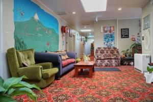 a living room with two couches and a table at Ariki Backpackers in New Plymouth