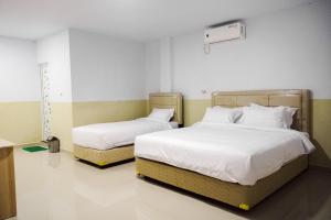 Ένα ή περισσότερα κρεβάτια σε δωμάτιο στο SANS Stay Manlie Hotel & Residence