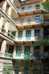 an apartment building with balconies on the side of it at Fanni Budapest Guesthouse in Budapest