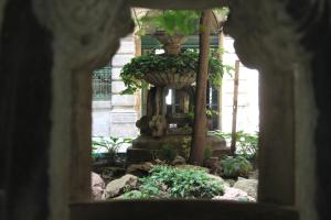a view of a fountain in a garden at Fanni Budapest Guesthouse in Budapest