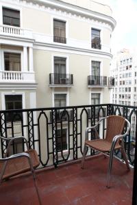 two chairs on the balcony of a building at Rincón de Gran Vía in Madrid