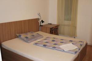 a bed in a bedroom with a lamp and a desk at Fanni Budapest Guesthouse in Budapest