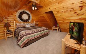 a bedroom with a bed in a log cabin at Think a Little Less in Gatlinburg