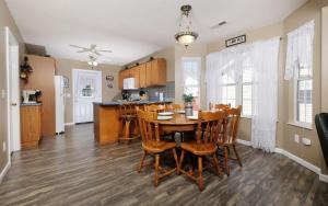 a kitchen and dining room with a table and chairs at Peace at the River in Pigeon Forge