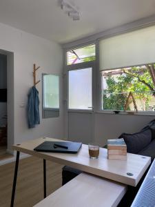 a living room with a table with a laptop on it at Elisaveta's Retreat. Come to feel the tranquility! in Râşnov