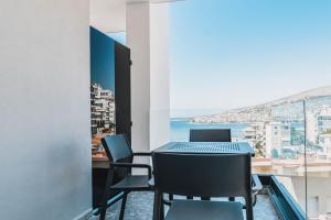 a table and chairs with a view of the ocean at Boe Luxury Hotel in Sarandë