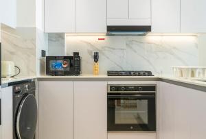 Nhà bếp/bếp nhỏ tại Stylish Comfort Modern 1BR Apt Prime Location JVC