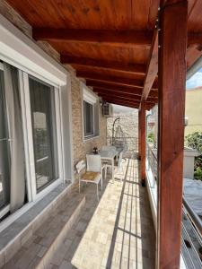 a patio with awning and a table and chairs at Nikos Apartament in Prinos