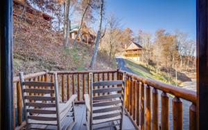 deux chaises assises sur un balcon donnant sur une maison dans l'établissement Lakeview Pointe, à Sevierville