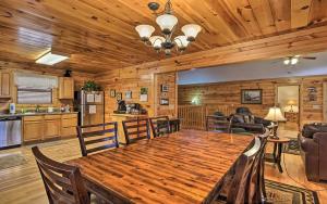 a dining room and kitchen with a large wooden table at Gatlinburg Mountain Heaven Retreat in Gatlinburg