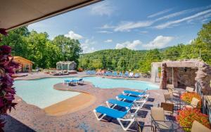 a pool at a resort with blue lounge chairs at The Foxtail Lodge in Gatlinburg