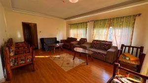 a living room with a couch and a table at Karibu guest house sipi in Kapchorwa