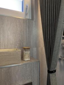 a curtain next to a shelf with a window at Elisaveta's Retreat. Come to feel the tranquility! in Râşnov