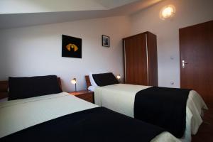 a hotel room with two beds and a cabinet at Apartment Paulina in Trogir