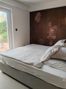 a bedroom with a large bed with a large window at Apartments Mirta in Rovinj