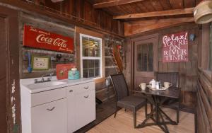 a kitchen with a sink and a table in a cabin at On River Time in Gatlinburg