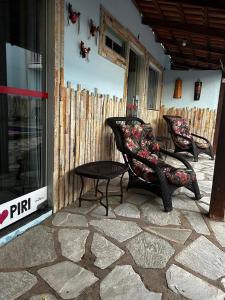 two chairs and a table on a patio at Pousada Love Piri in Pirenópolis +52 photos