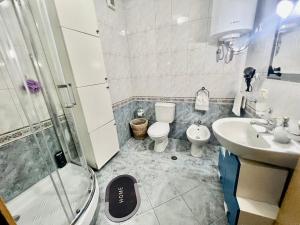 a bathroom with a shower and a toilet and a sink at Rita Apartment in Tirana centre in Tirana +14 photos