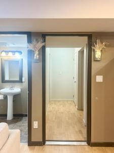 a hallway with a door open to a bathroom at Peaceful House with Backyard in Langley
