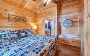 a log cabin bedroom with a bed and a tub at Ever After Gatlinburg in Gatlinburg