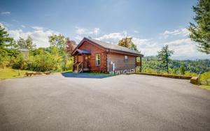 a cabin in the woods with a driveway at Ever After Gatlinburg in Gatlinburg