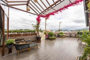 a patio with tables and chairs on a roof at Jodi Dalat Hotel in Da Lat