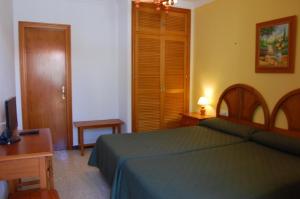 Postel nebo postele na pokoji v ubytování Hotel Antonio Conil